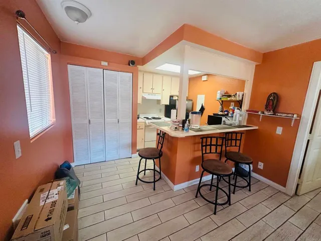 a dining room with furniture and a window