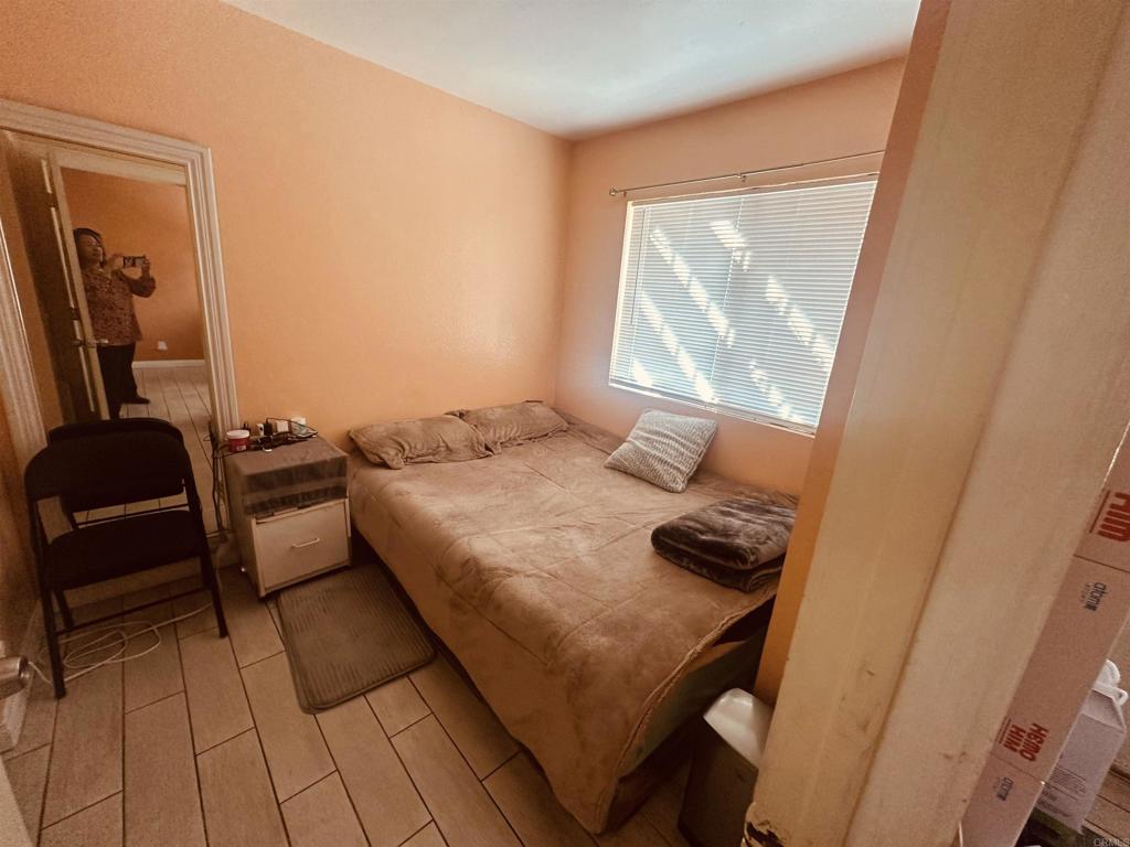891 West San Ysidro Boulevard, Unit 9 San Ysidro, CA 92173 - Photo 9 of 18 a bedroom with a bed and a window