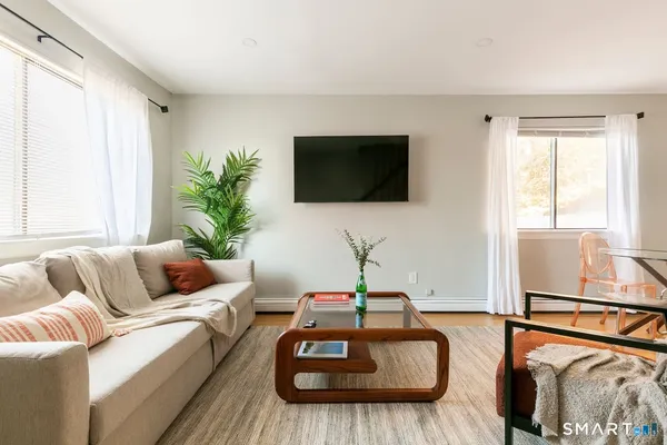a living room with furniture and a flat screen tv