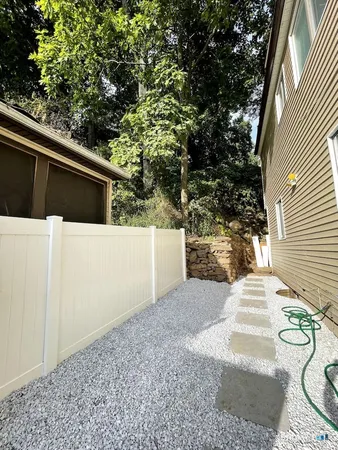 a side view of a house with a yard