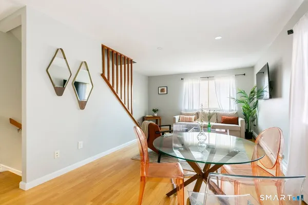 a dining room with furniture and a potted plant