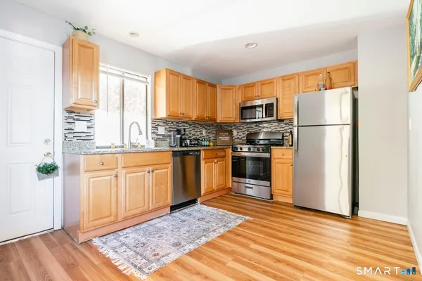 a kitchen with stainless steel appliances granite countertop a refrigerator sink and cabinets