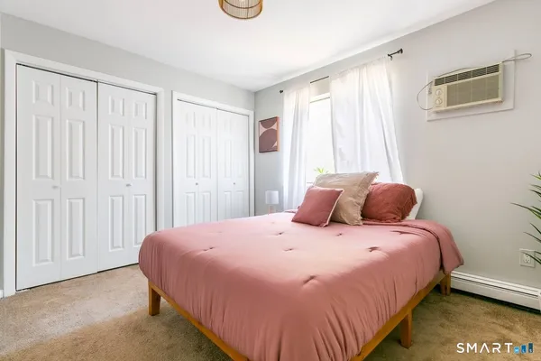 a bedroom with a bed and a window