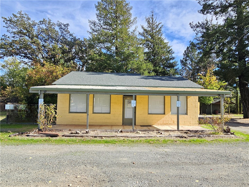 a front view of house with yard and trees around