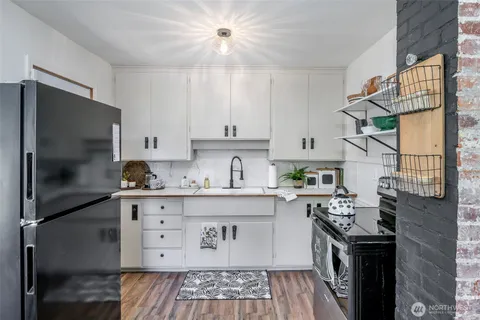 a kitchen with stainless steel appliances granite countertop a stove a refrigerator and a cabinets