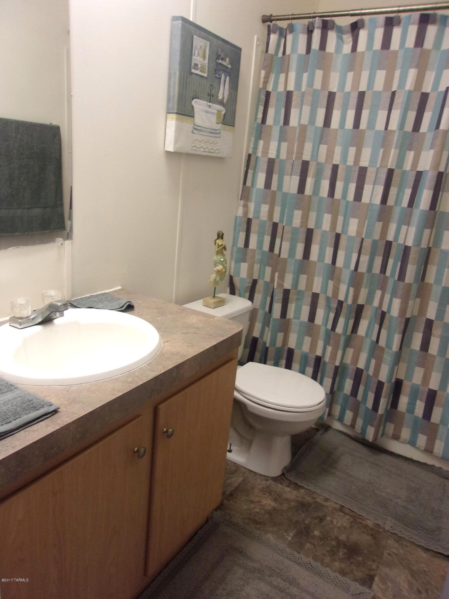 307 West King Road Tucson, AZ 85705 - Photo 9 of 17 a bathroom with a toilet a sink and a mirror