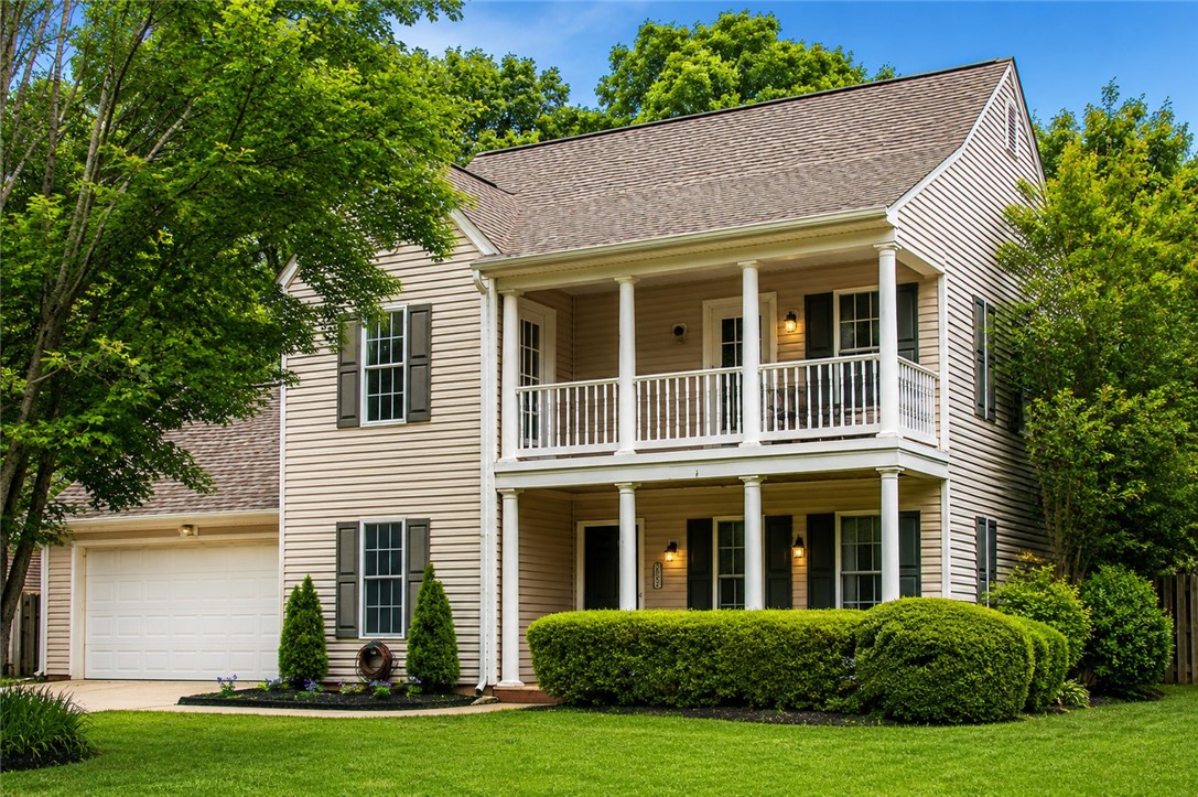 328 Springfield Circle Easley, SC 29642 - Photo 2 of 29 A classic two-story residence with double balconies and a well-kept lawn, offering inviting curb appeal.