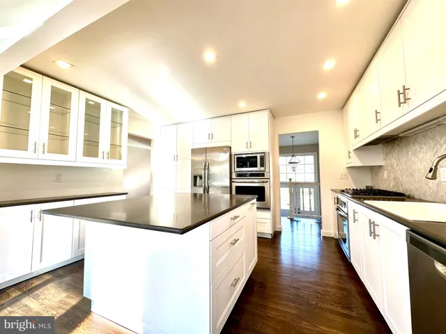 a kitchen with stainless steel appliances granite countertop a stove and a sink