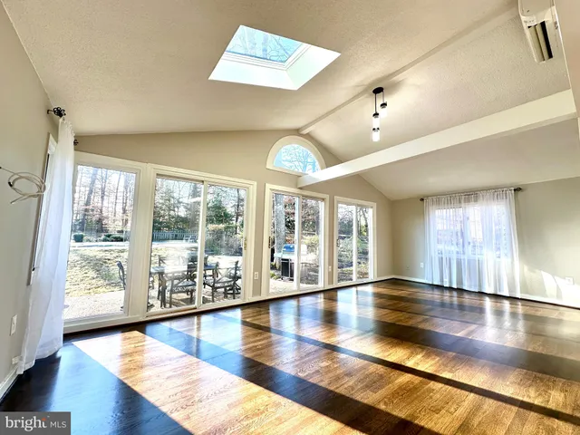 a view of an entryway with wooden floor