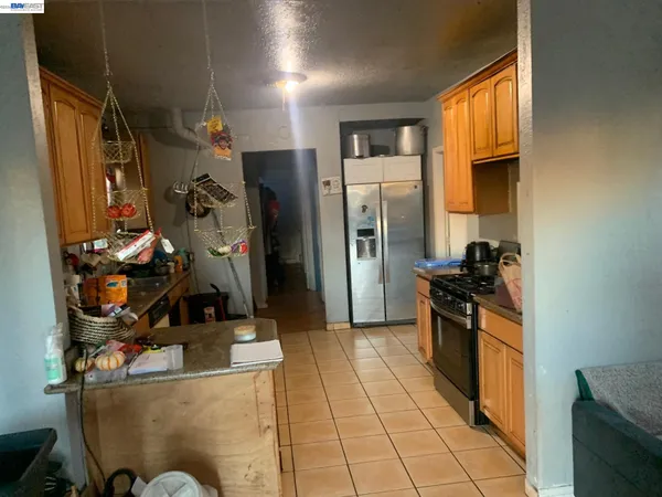 a kitchen with stainless steel appliances a sink stove and cabinets