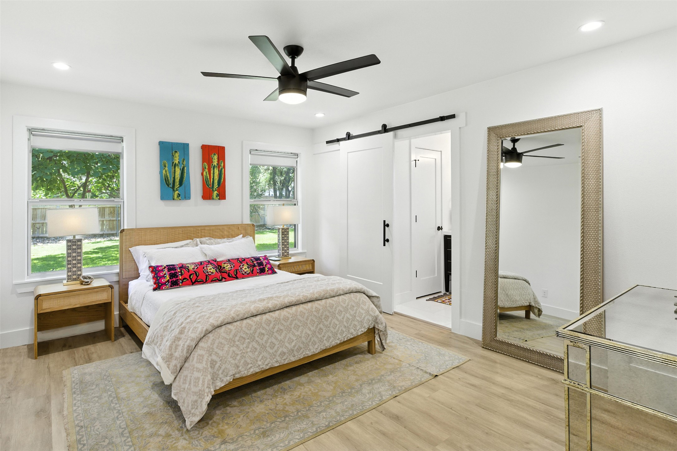 2403 Gateshead Circle Austin, TX 78745 - Photo 16 of 22 A tranquil bedroom with warm wood flooring and a modern ceiling fan, offering direct outdoor views.