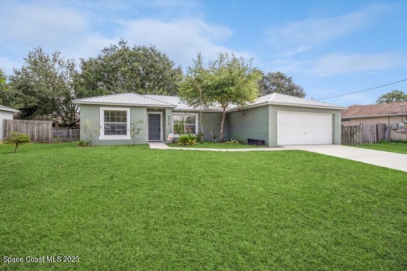 6475 Addax Avenue Cocoa, FL 32927 - Photo 1 of 31 a front view of house with yard and green space