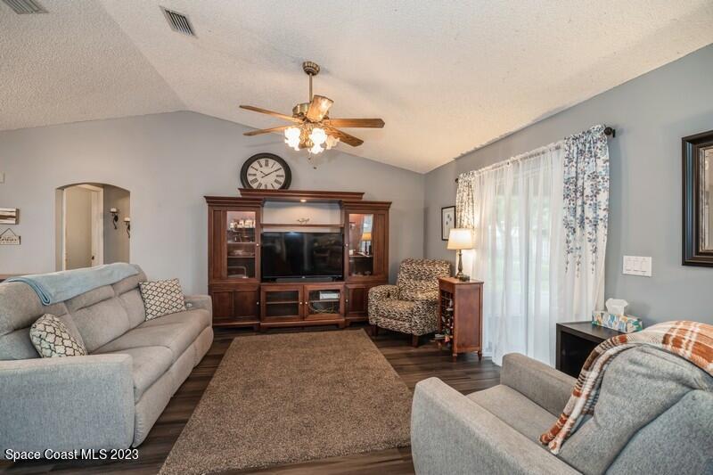 6475 Addax Avenue Cocoa, FL 32927 - Photo 11 of 31 a living room with furniture a large window and a flat screen tv