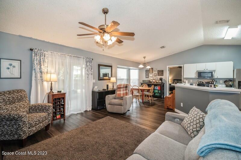 6475 Addax Avenue Cocoa, FL 32927 - Photo 12 of 31 a living room with furniture and kitchen view