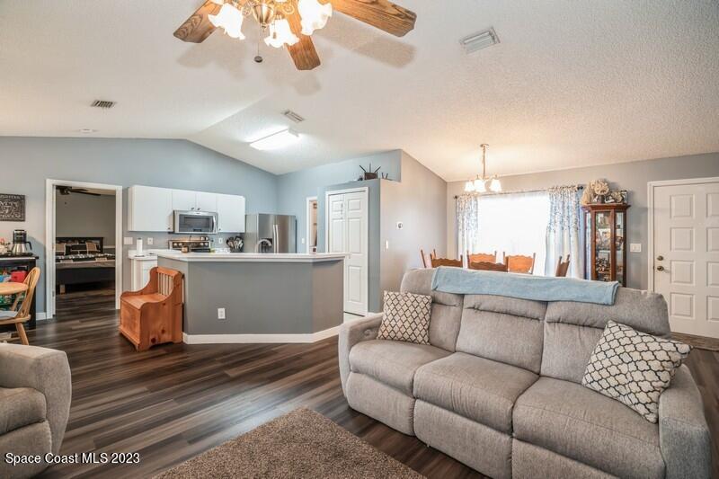 6475 Addax Avenue Cocoa, FL 32927 - Photo 14 of 31 a living room with furniture and kitchen view