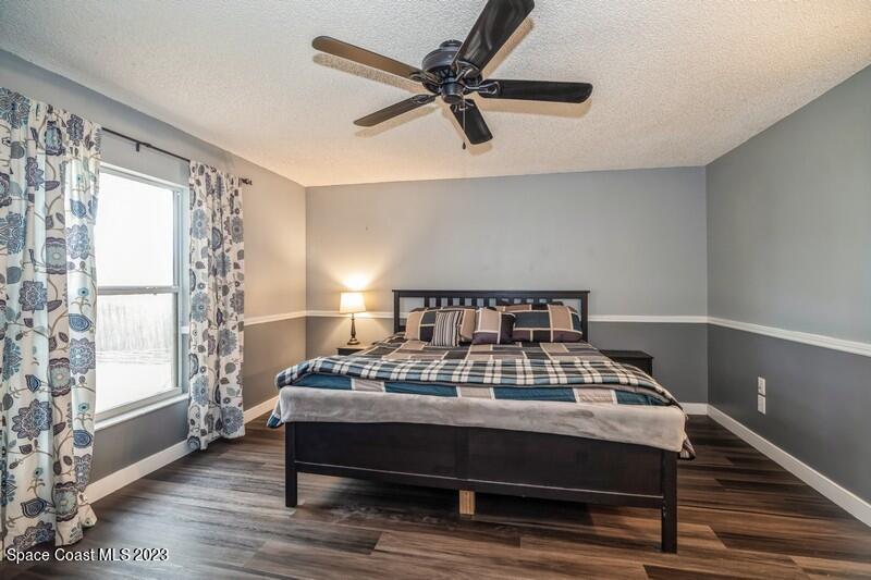 6475 Addax Avenue Cocoa, FL 32927 - Photo 15 of 31 a bedroom with a bed and a window
