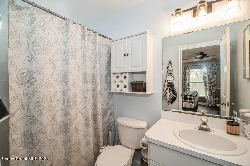 6475 Addax Avenue Cocoa, FL 32927 - Photo 18 of 31 a bathroom with a toilet sink and mirror