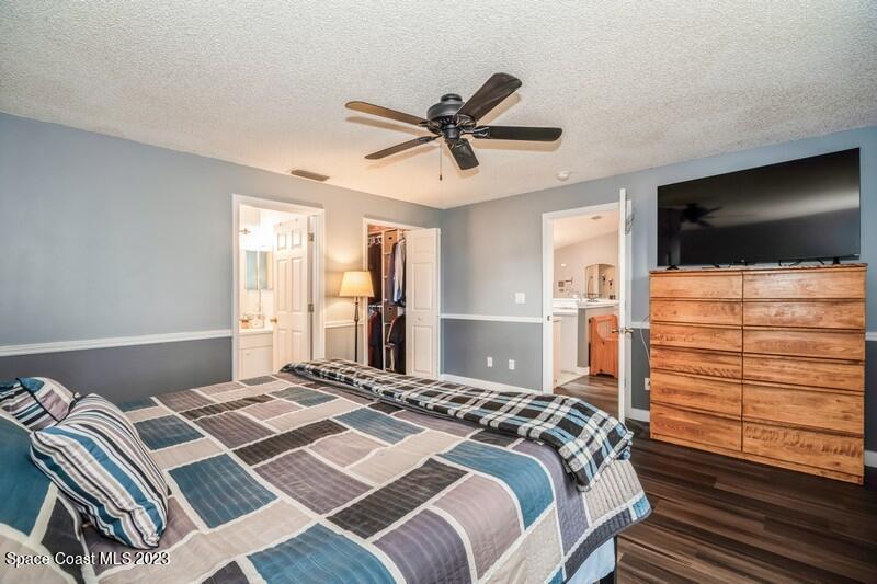 6475 Addax Avenue Cocoa, FL 32927 - Photo 19 of 31 a bedroom with a bed and a flat screen tv