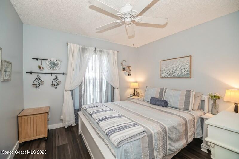 6475 Addax Avenue Cocoa, FL 32927 - Photo 21 of 31 a bedroom with a bed and wooden floor