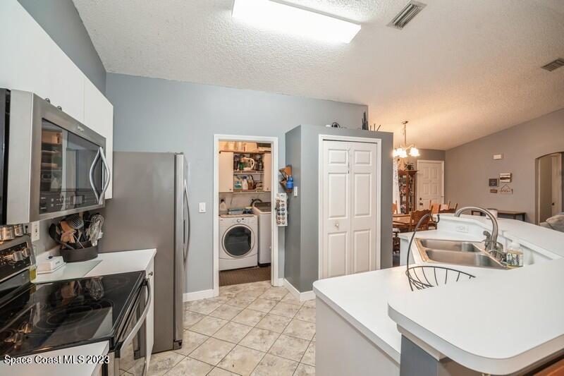 6475 Addax Avenue Cocoa, FL 32927 - Photo 6 of 31 a kitchen with a refrigerator a sink and a stove
