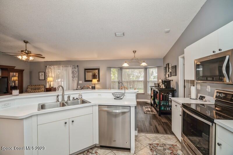 6475 Addax Avenue Cocoa, FL 32927 - Photo 7 of 31 a kitchen with sink stove and refrigerator