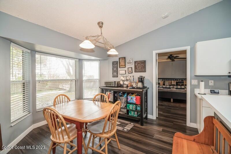 6475 Addax Avenue Cocoa, FL 32927 - Photo 8 of 31 a view of a dining room with furniture window and wooden floor