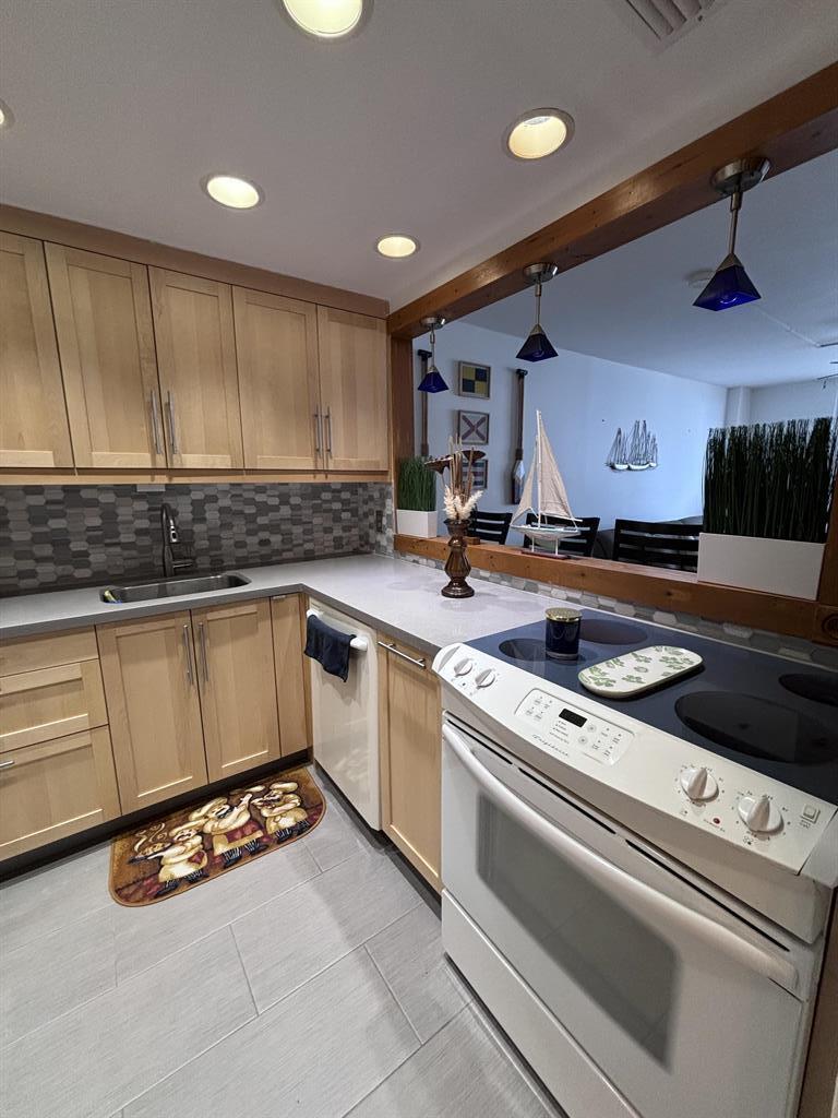 336 North Birch Road, Unit 8D Fort Lauderdale, FL 33304 - Photo 21 of 23 a kitchen with granite countertop a stove a sink and a microwave