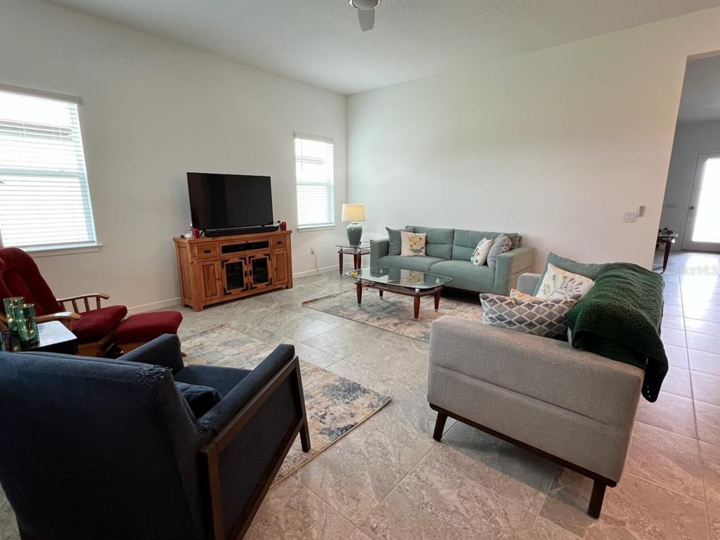 6046 Southwest 86th Circle Ocala, FL 34481 - Photo 15 of 79 a living room with furniture and a flat screen tv