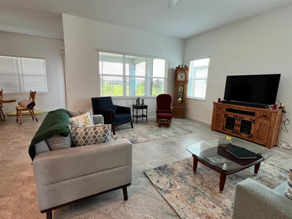 6046 Southwest 86th Circle Ocala, FL 34481 - Photo 16 of 79 a living room with furniture and a flat screen tv