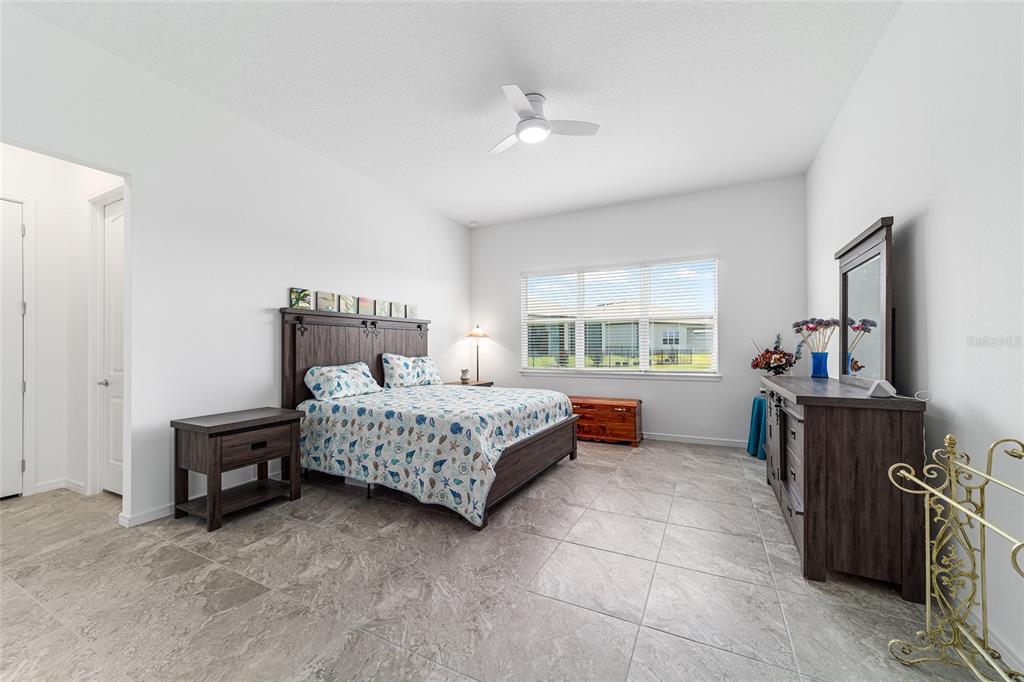 6046 Southwest 86th Circle Ocala, FL 34481 - Photo 32 of 79 a bedroom with a bed and a table in it