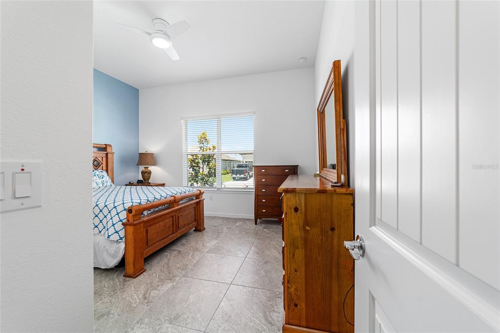 6046 Southwest 86th Circle Ocala, FL 34481 - Photo 43 of 79 a room with a bed and a chandelier