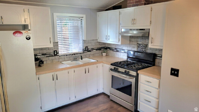 1525 South 400 East, Unit 63 Springville, UT 84663 - Photo 8 of 36 Kitchen featuring gas range, freestanding refrigerator, light countertops, white cabinetry, and ventilation hood