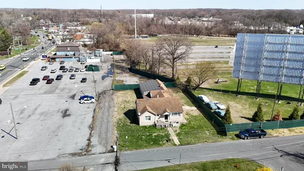 an aerial view of a house with a yard and lake view