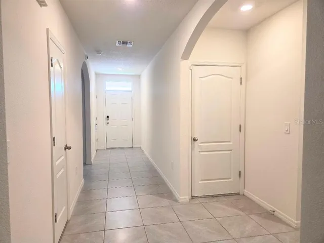 a view of hallway with a bathroom