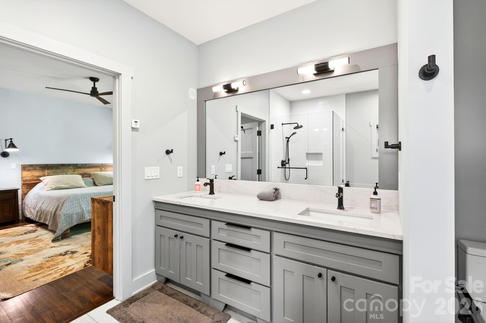 235 Bull Creek Road Asheville, NC 28805 - Photo 13 of 47 a en suite bathroom with double vanity sinks and a mirror