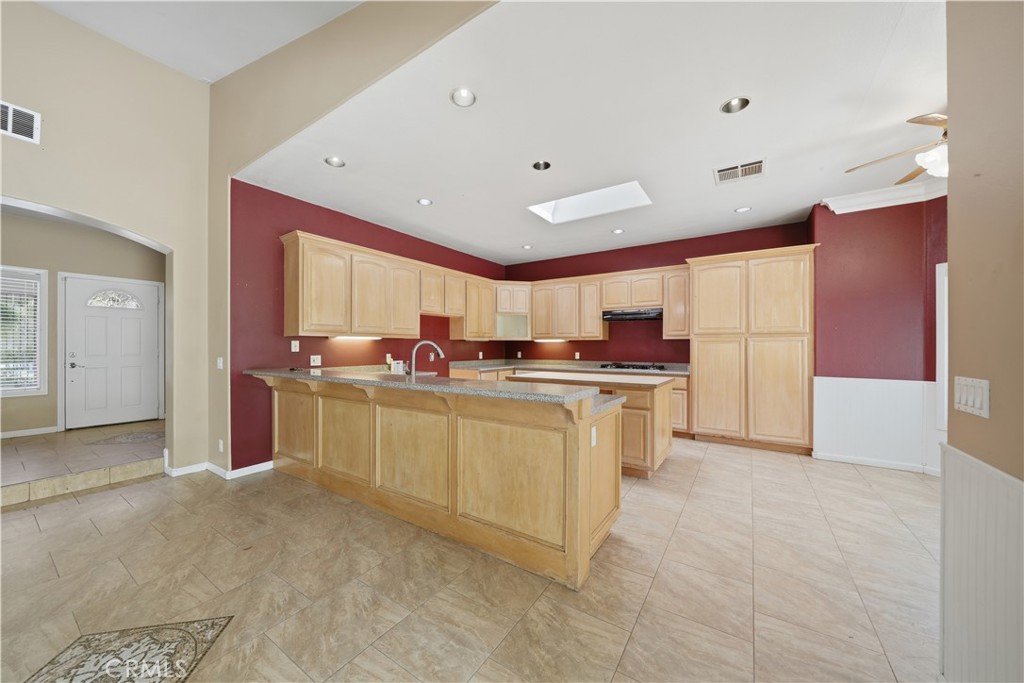 32245 Refa Street Wildomar, CA 92595 - Photo 12 of 69 a kitchen with stainless steel appliances granite countertop a stove a sink and a refrigerator