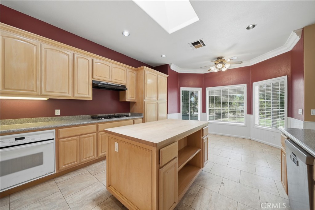 32245 Refa Street Wildomar, CA 92595 - Photo 17 of 69 a kitchen with a stove sink and cabinets