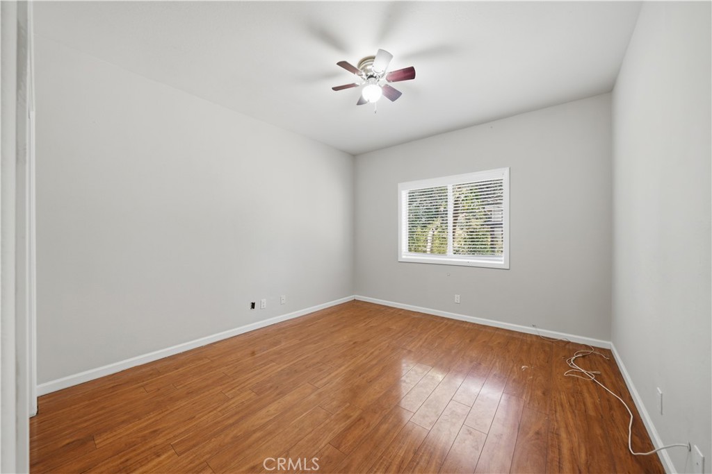 32245 Refa Street Wildomar, CA 92595 - Photo 20 of 69 an empty room with wooden floor and windows