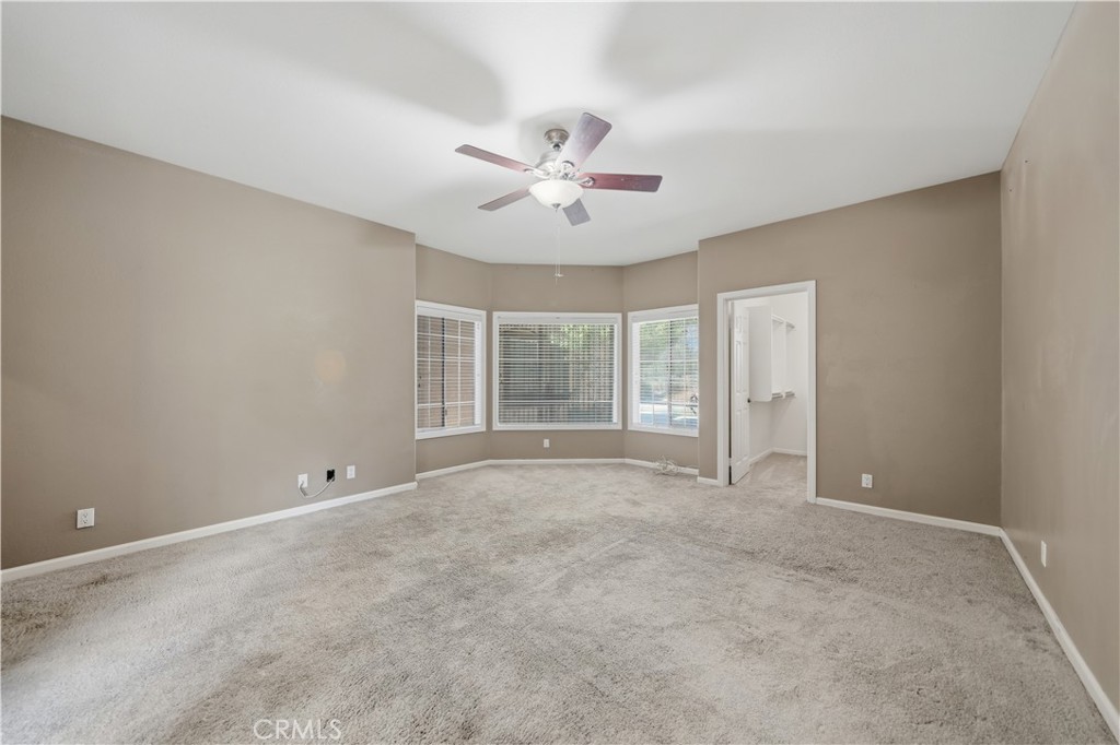 32245 Refa Street Wildomar, CA 92595 - Photo 25 of 69 an empty room with chandelier fan and windows