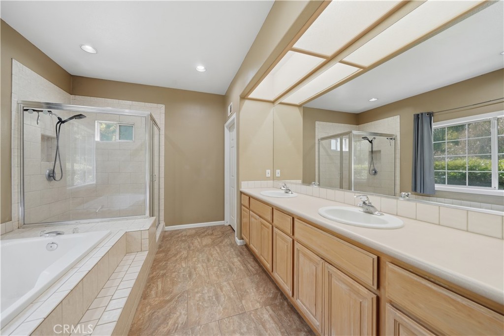 32245 Refa Street Wildomar, CA 92595 - Photo 27 of 69 a spacious bathroom with a tub sink shower and mirror