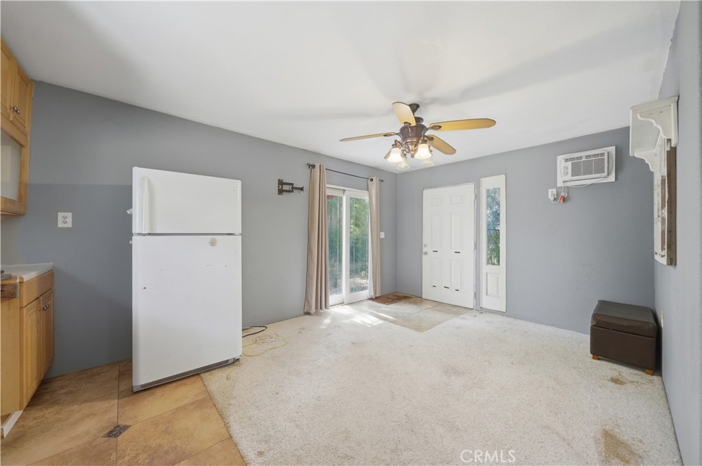 32245 Refa Street Wildomar, CA 92595 - Photo 38 of 69 a view of a livingroom with a ceiling fan and a kitchen