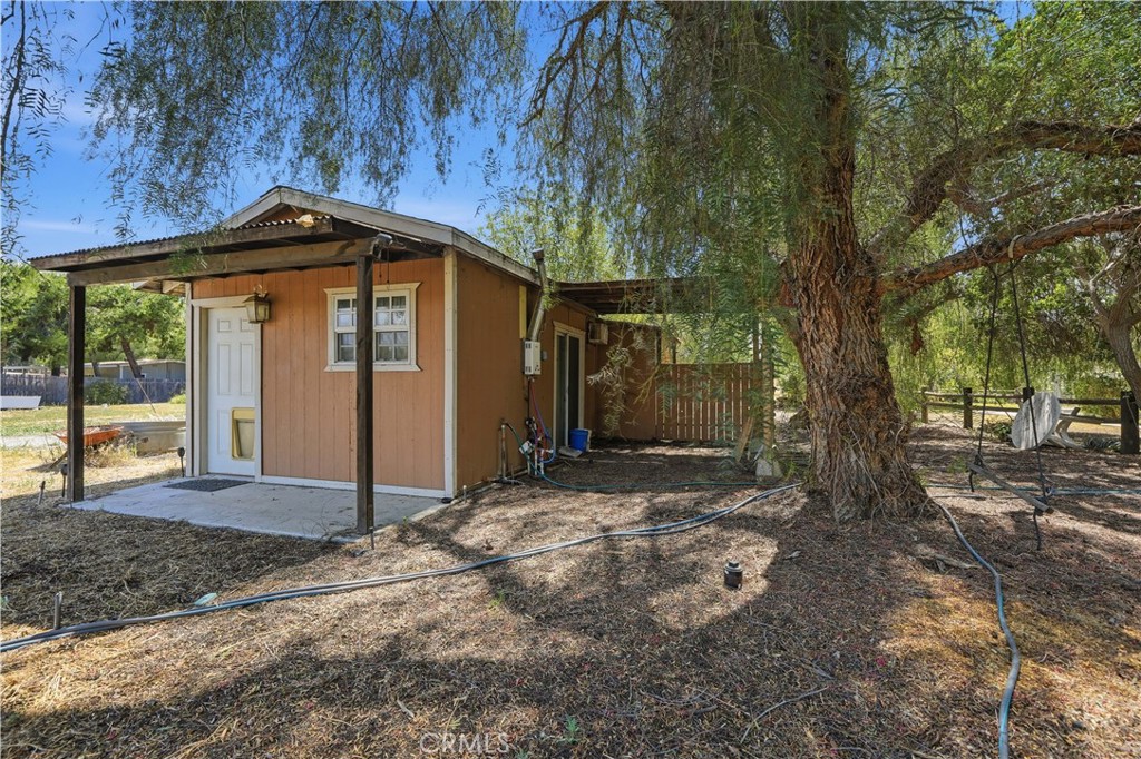 32245 Refa Street Wildomar, CA 92595 - Photo 48 of 69 a view of a small house with a tree in the background