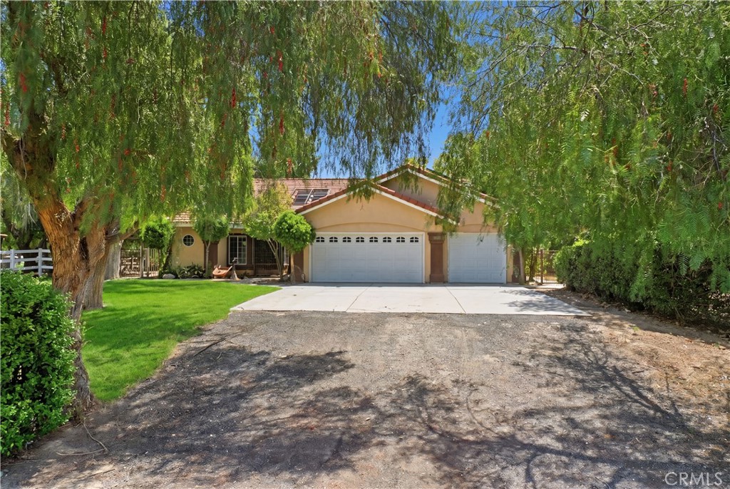 32245 Refa Street Wildomar, CA 92595 - Photo 59 of 69 a front view of a house with a yard and garage