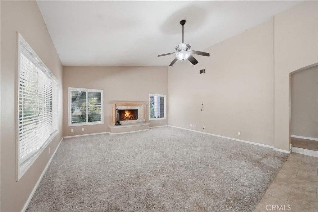 32245 Refa Street Wildomar, CA 92595 - Photo 8 of 69 en empty room with windows and a ceiling fan