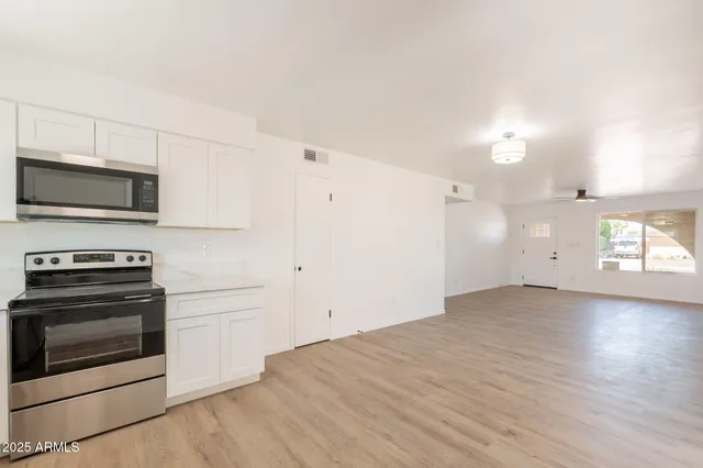 a view of a kitchen with a sink oven and window