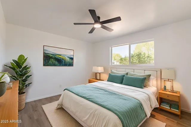 a bedroom with a bed and a potted plant