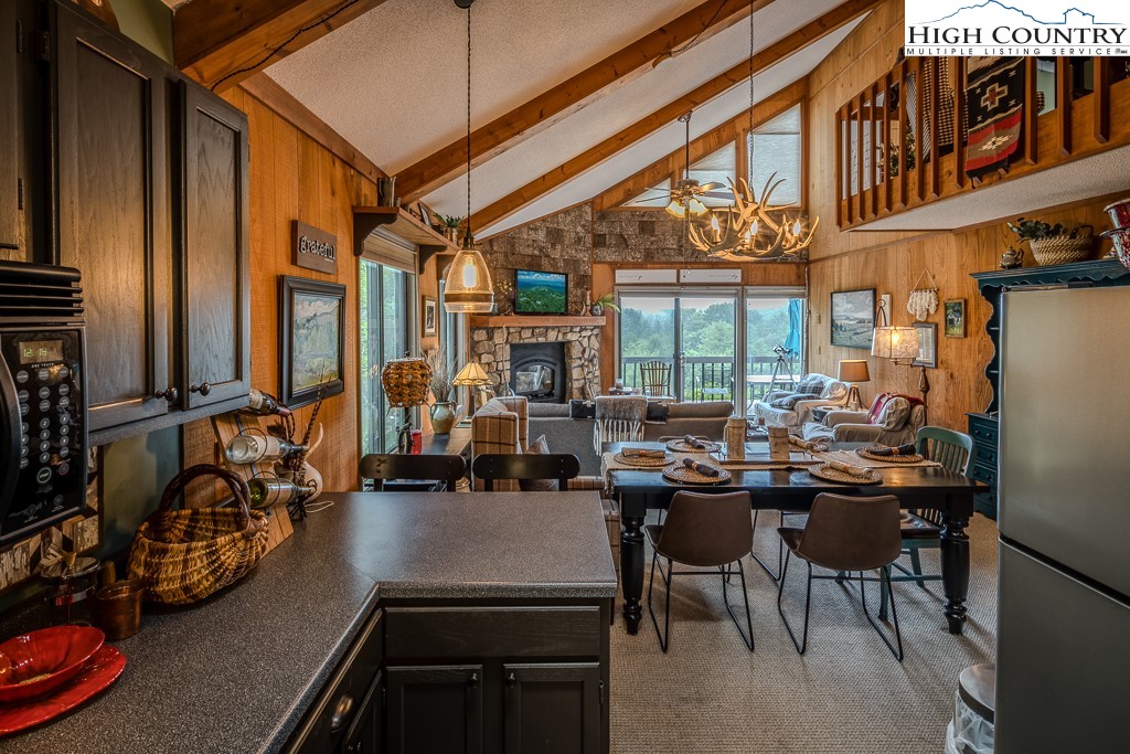 102 Spring Branch Road, Unit E Beech Mountain, NC 28604 - Photo 12 of 40 a view of a dining room with furniture window and outside view