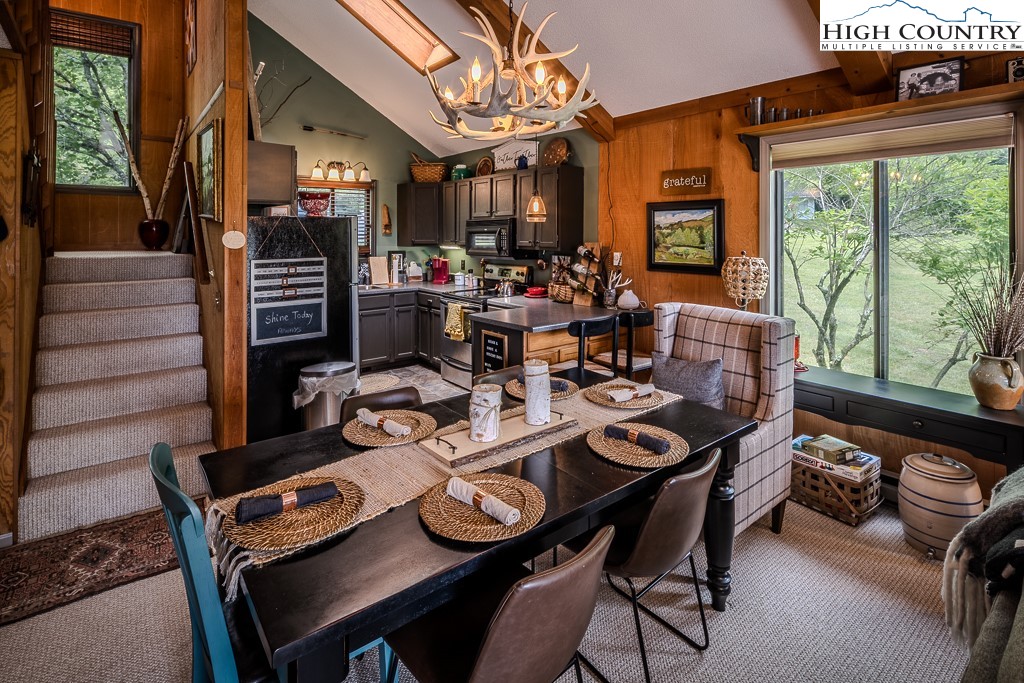 102 Spring Branch Road, Unit E Beech Mountain, NC 28604 - Photo 13 of 40 a view of a dining room with furniture window and outside view