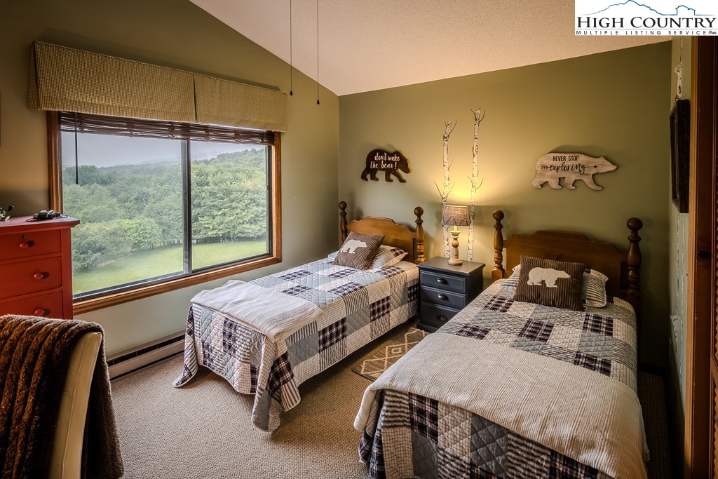 102 Spring Branch Road, Unit E Beech Mountain, NC 28604 - Photo 25 of 40 a bedroom with two beds and a large window