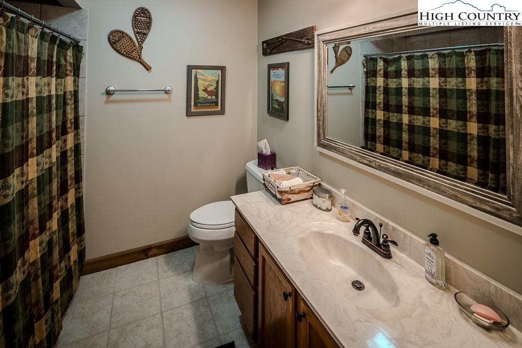 102 Spring Branch Road, Unit E Beech Mountain, NC 28604 - Photo 29 of 40 a bathroom with a sink and a mirror